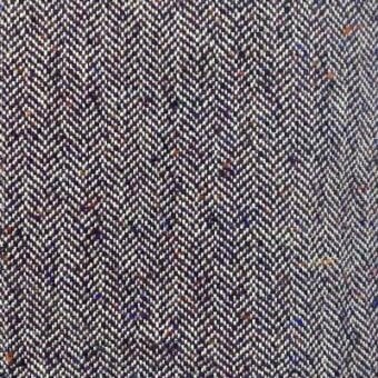 Herringbone fabric texture in deep plum with orange, blue, and cream flecks, featuring alternating diagonal weave lines and a speckled pattern.